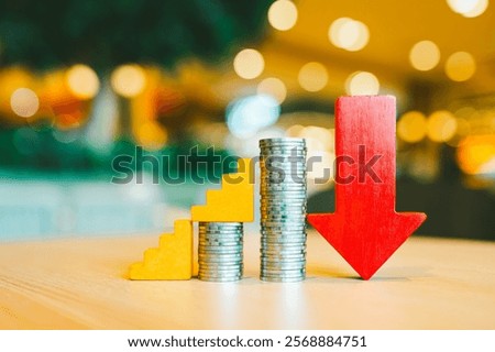 Down arrow with coin stack. Key concepts for success, methods, systems of raising or lowering Fed interest rates to correct inflation concepts.