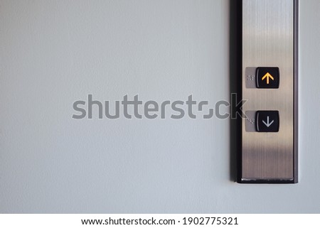 Up and down button in front of the Elevator for direction, up red light with copy space