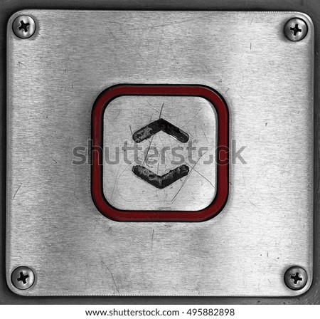 An up and down elevator touch button on a metal panel.

