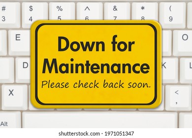Down For Maintenance Please Check Back Soon Message On A Red Sign On A White Keyboard 
