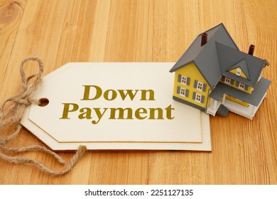 Down Payment Gift rules on gift tag with a house on a wood desk