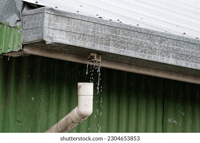 A down spout has come loose so the water it is meant to be catching is pouring out of the gutter