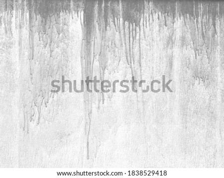 Down streams of gray paint on the wall. Creative background, design element of interior or other ideas.
