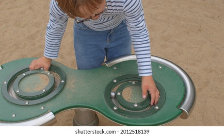 Down Syndrome Child Plays, Outdoor Challenge. Special Needs Outdoor Playground Equipment Stimulate SEN Children's Senses, Develop Social Skills And Encourage Heavy Work Activities. Lifestyle.