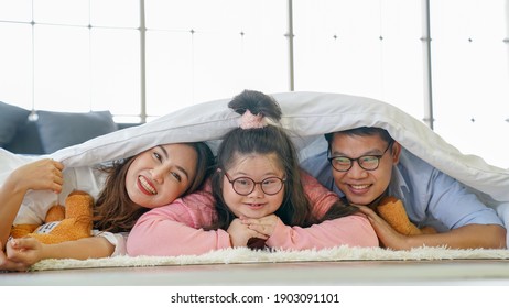 Down syndrome Happy family parents go to bed at the same time