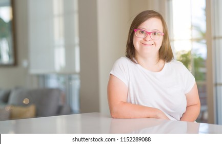 Down syndrome woman at home with a happy face standing and smiling with a confident smile showing teeth - Shutterstock ID 1152289088