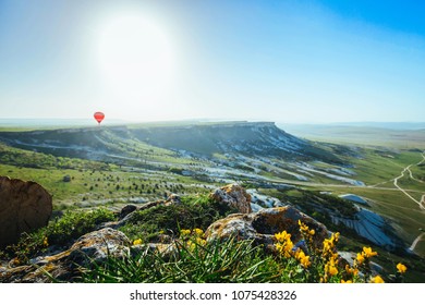 Down view form mountain valley. Natural summer landscape. Green grass and yellow flowers foreground