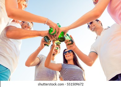 Down View Of Young Happy Friends Enjoying Beach Party With Beer