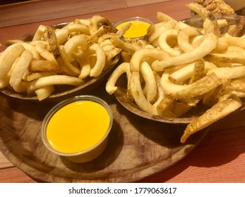 Downers Grove, IL / USA - 7/18/2020 : HOOTERS Curly Cue Fries Platter And Cheese Dip Served On Wooden Platters. 