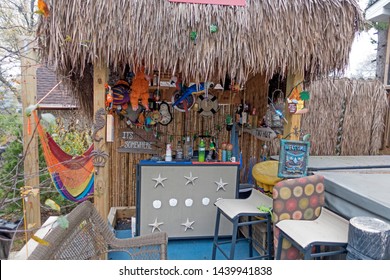 DOWNERS GROVE, ILLINOIS - NOVEMBER 15, 2016: A Well Appointed Tiki Bar On The Deck With Grass Roof And Hammock. 