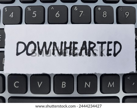 Downhearted writting on laptop keyboard background.