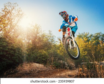 Downhill Cycling. Man High Jump On A Mountain Bike. Extreme Sport.