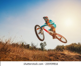 Downhill Cycling. Man High Jump On A Mountain Bike. Extreme Sport.