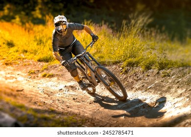 Downhill mountain biker in equipment going fast in the bike park trail. - Powered by Shutterstock