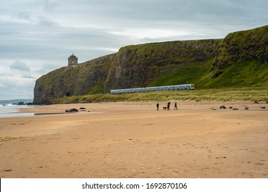 Downhill, Northern Ireland, UK - Jun 17, 2018: Train Coming Out Of The Mountain Tunnel