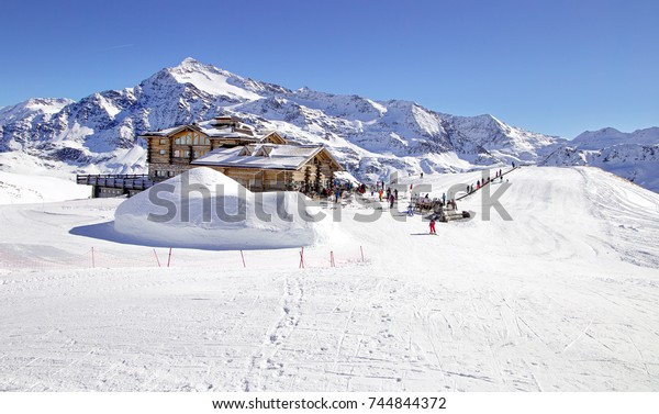 Downhill slope and apres ski mountain hut with\
restaurant terrace in the Italian Alps, Europe, Italy. Ski area\
Santa Caterina\
Valfurva