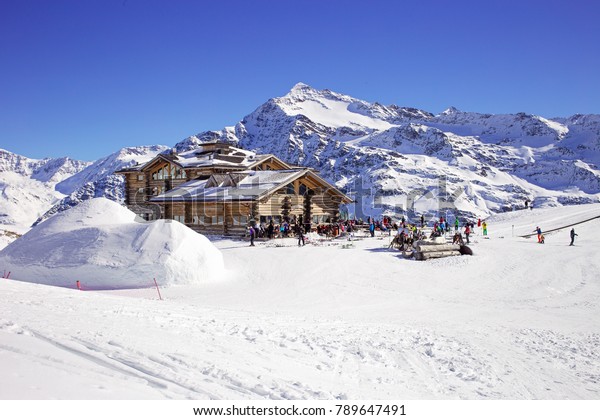 Downhill slope and apres ski mountain hut with\
restaurant terrace in the Italian Alps, Europe, Italy. Ski area\
Santa Caterina\
Valfurva