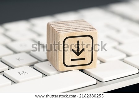 Download icon on wooden block on computer keyboard. Downloading data storage