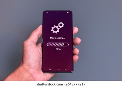 Downloading process bar on phone screen. Man using smartphone to download media or update software.