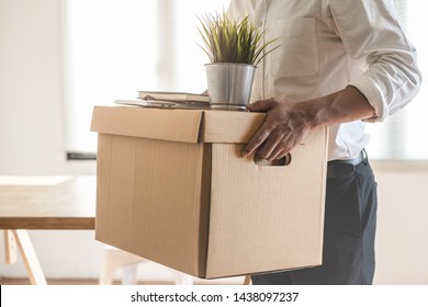 Downsize business. Employee moving off from office after sacked from company.
