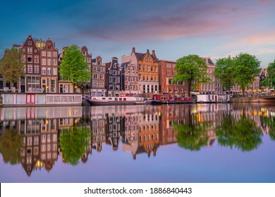 Downtown Amsterdam city skyline. Cityscape  in Netherlands at sunset