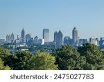 Downtown Atlanta Skyline showing several prominent buildings and hotels under a blue sky.