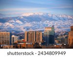 Downtown Boise, Idaho skyline and the snow covered foothills and Bogus Basin Ski Resort in March of 2024