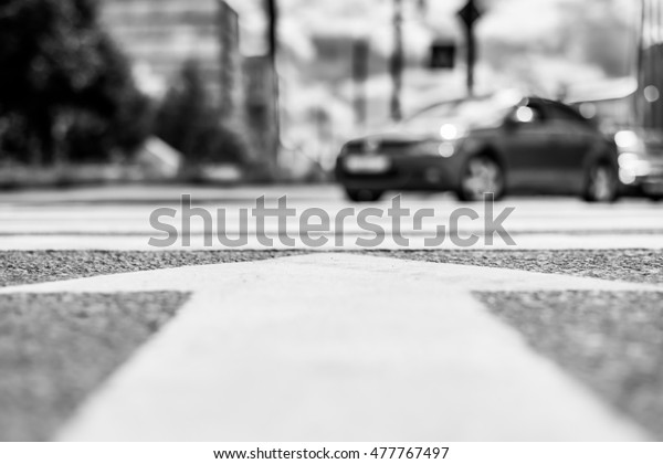 In the downtown, the car turn at the crossroads.\
View from the pedestrian crossing level, image in the black and\
white tones