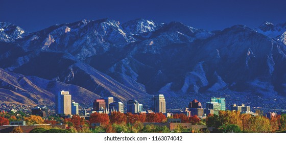Downtown city skyline of Salt Lake City, Utah, with the Wasatch mountains in the background in afternoon sunshine. - Shutterstock ID 1163074042