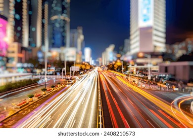 downtown cityscape at night with rush-hour traffic in China - Powered by Shutterstock