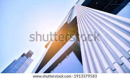 Downtown corporate business district architecture. Glass reflective office buildings against blue sky and sun light. Economy, finances, business activity concept.