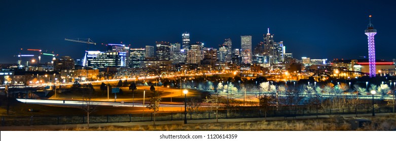 Downtown Denver, Colorado night city skyline on West side with streetlights and buildings for urban landscape.
