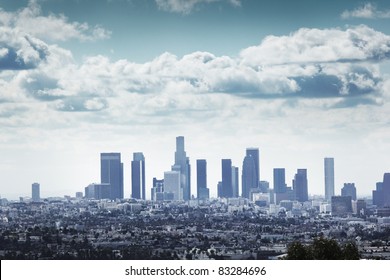 Downtown Los Angeles skyline over blue cloudy sky