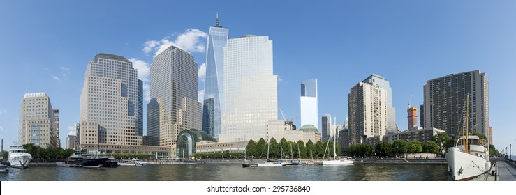 Downtown Manhattan New York City skyline featuring modern office towers under bright blue sky panorama