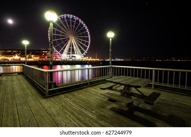 Downtown Seattle, Washington, USA - April 16, 2017 - Night Scene In The Waterfront Park With Ferris Wheel In The Background.