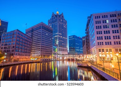 Downtown skyline with Buildings along the Milwaukee River at night, in Milwaukee, Wisconsin.