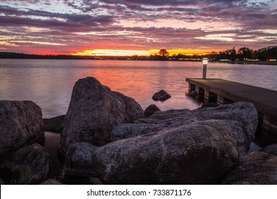 Downtown Traverse City Coastal Sunrise. Morning sunrise over the rocky coast of Grand Traverse Bay with downtown Traverse City, Michigan in the background. - Shutterstock ID 733871176