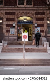 DOWNTOWN VANCOUVER, BC, CANADA - APR 01, 2020: Person Wearing A Medical Face Mask Outside St Pauls Hospital In Vancouver During The Covid 19 Pandemic.