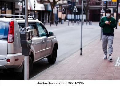 DOWNTOWN VANCOUVER, BC, CANADA - APR 01, 2020: Street parking bylaws are no longer being enforced due to quarantine measures taken in light of the Covid 19 pandemic.