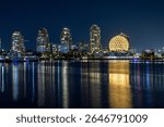 Downtown Vancouver British Columbia Canada view of science world at night with reflection in water