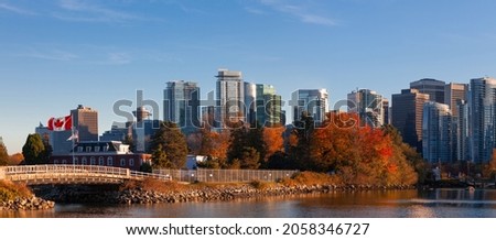 Downtown Vancouver Canada modern city panorama view Coal Harbor business district area high office and apartment buildings with Naval Museum at HMCS Naval Reserve with a large Canadian flag
