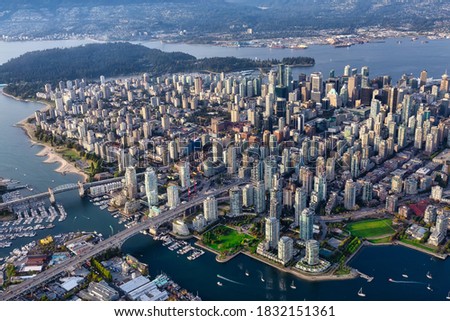 Downtown Vancouver City, British Columbia, Canada. Beautiful Aerial View from Above of a Modern Cityscape. Colorful Vibrant Sunset. Urban Buildings, Bridges and Streets.