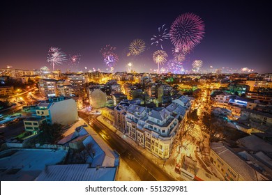 Downtown Varna cityscape with many flashing fireworks celebrating New Year's Eve