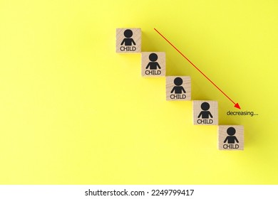 Downward graph composed by wooden blocks with child pictogram - Shutterstock ID 2249799417