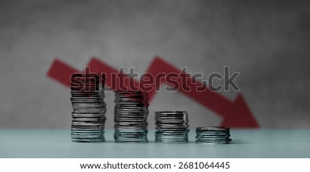 Downward red arrow with shrinking stacks of coins, depicting global recession, economic downturn, and significant financial loss.