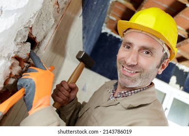 Downward View Of Builder Holding Sledge Hammer