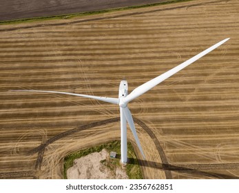 Downward view of a large generic wind turbine showing is foundations and seen in a farm field in East Anglia, UK.