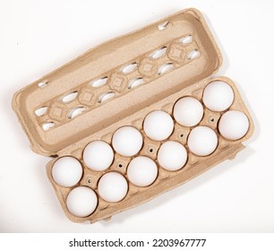 Dozen Eggs In Brown Carton  On White Background