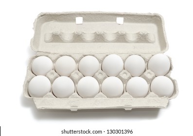 A Dozen Eggs In A Carton Isolated On White Background