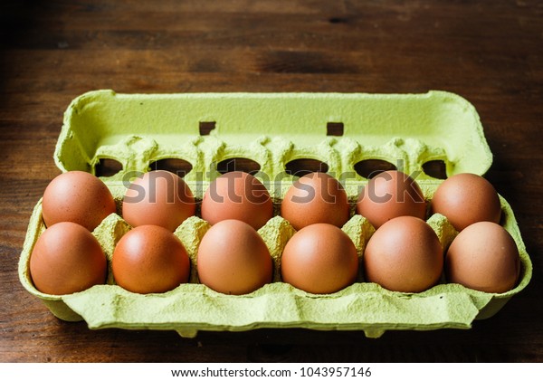 a dozen\
eggs in its protective box ready for\
sale
